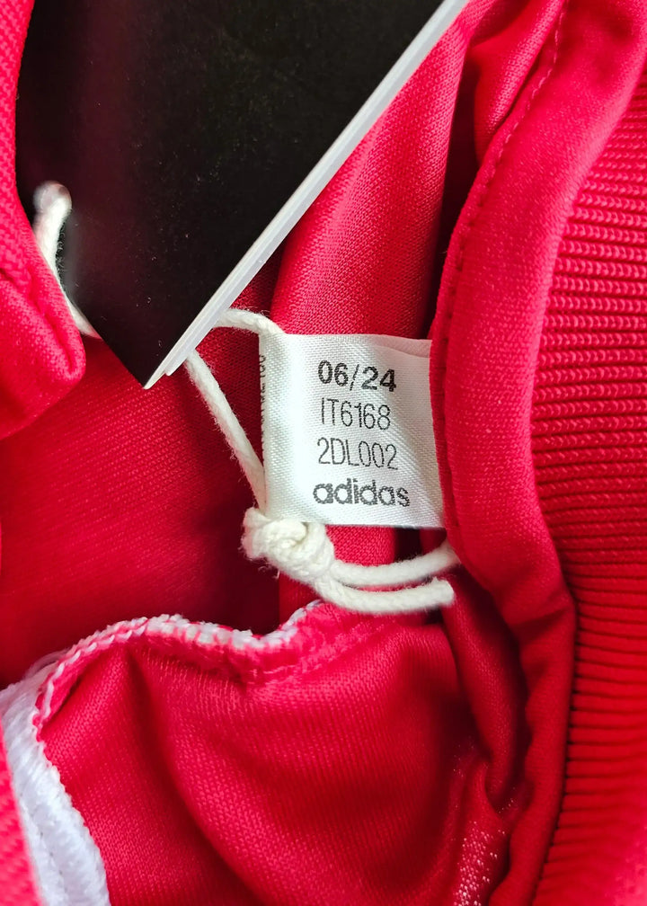 Care label showing size details and adidas brand inside the shirt.