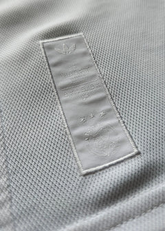 Crest detail featuring AFC Ajax 125th Anniversary text and three stars on the label.