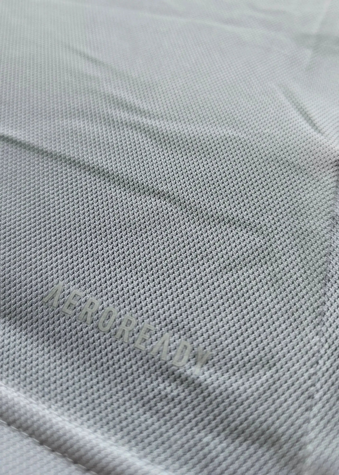 Close-up showing 'AEROREADY' text on fabric of Sjaak Swart Ajax signed shirt.
