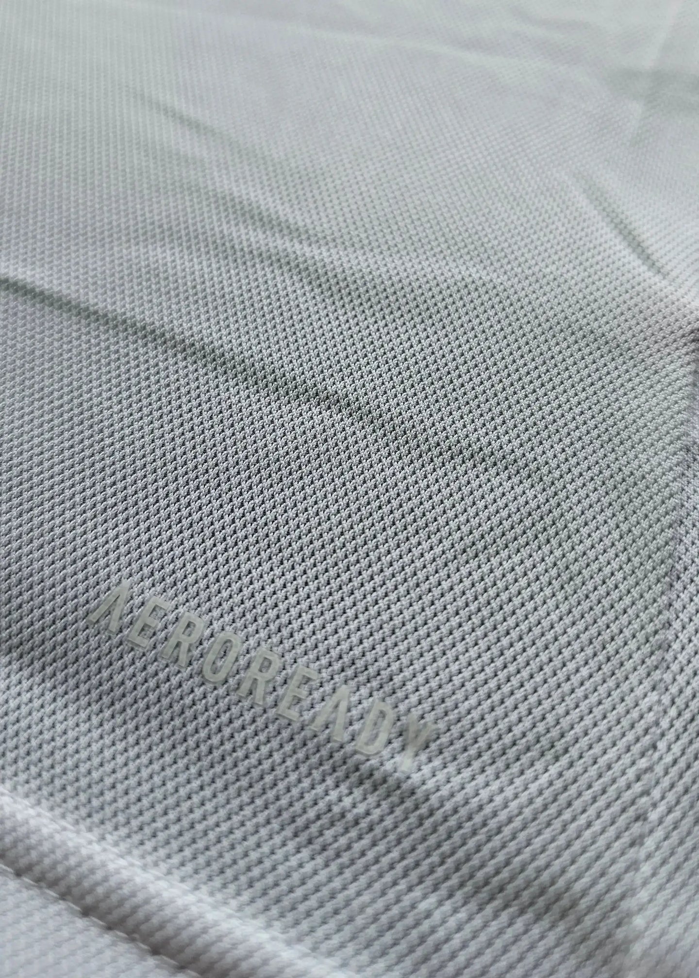 Close-up showing 'AEROREADY' text on fabric of Sjaak Swart Ajax signed shirt.