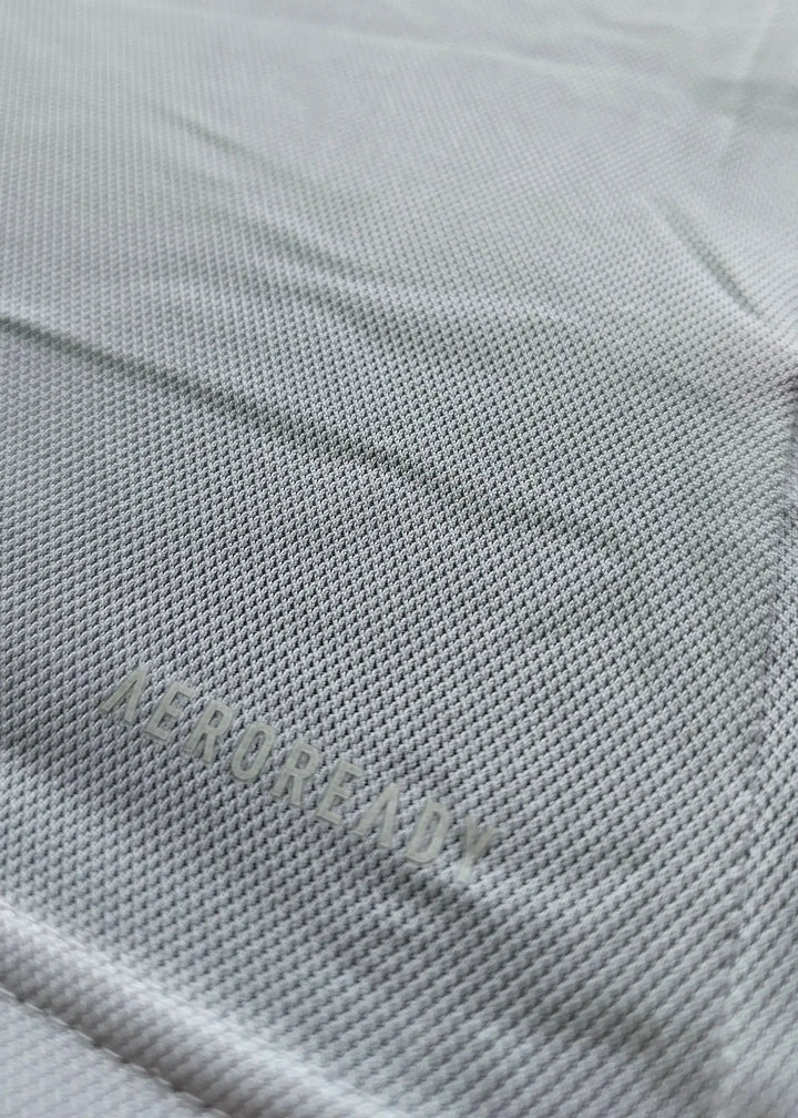 Close-up showing 'AEROREADY' text on fabric of Sjaak Swart Ajax signed shirt.