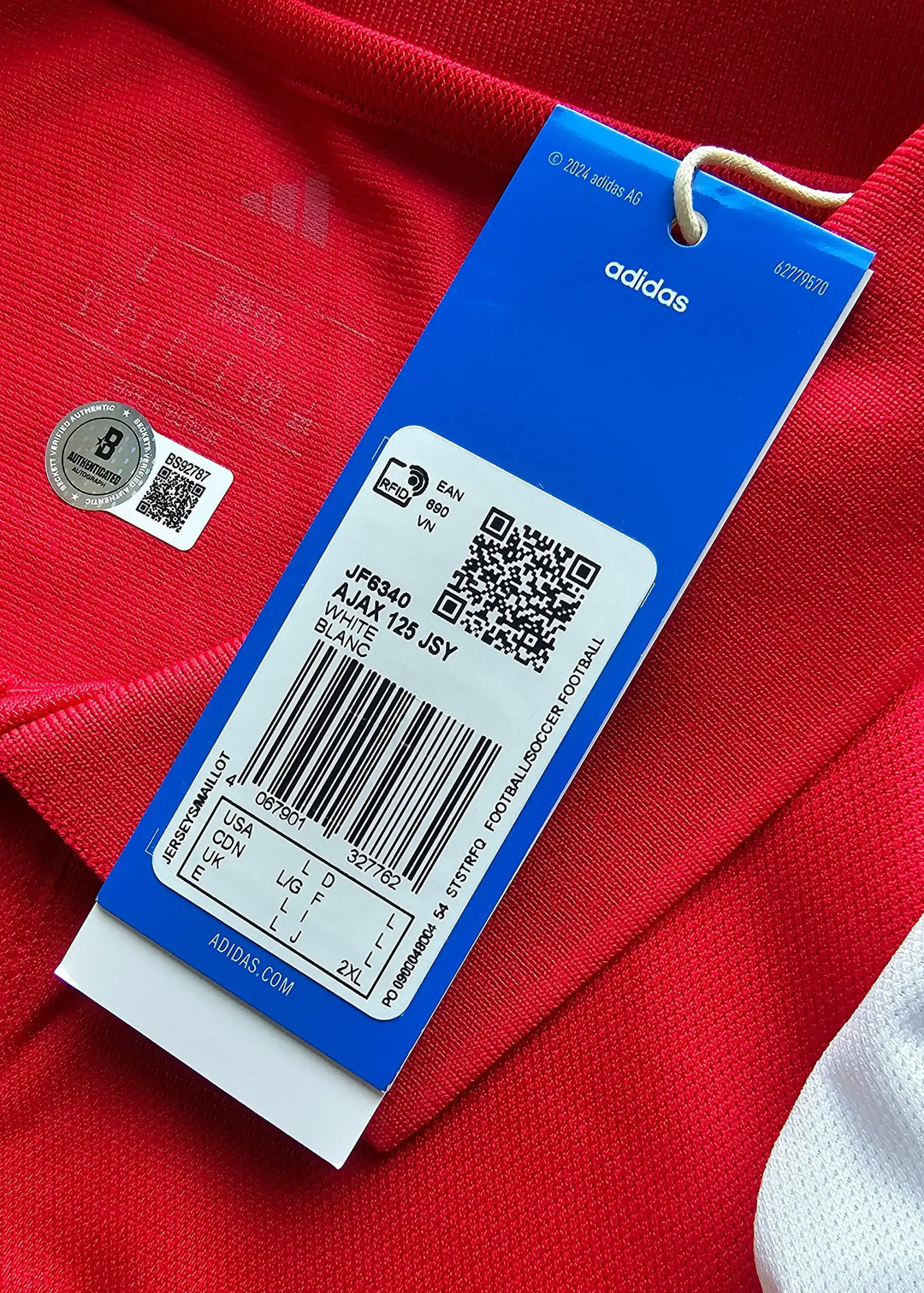 Care label showing size and care instructions for Ajax 125th anniversary signed shirt.