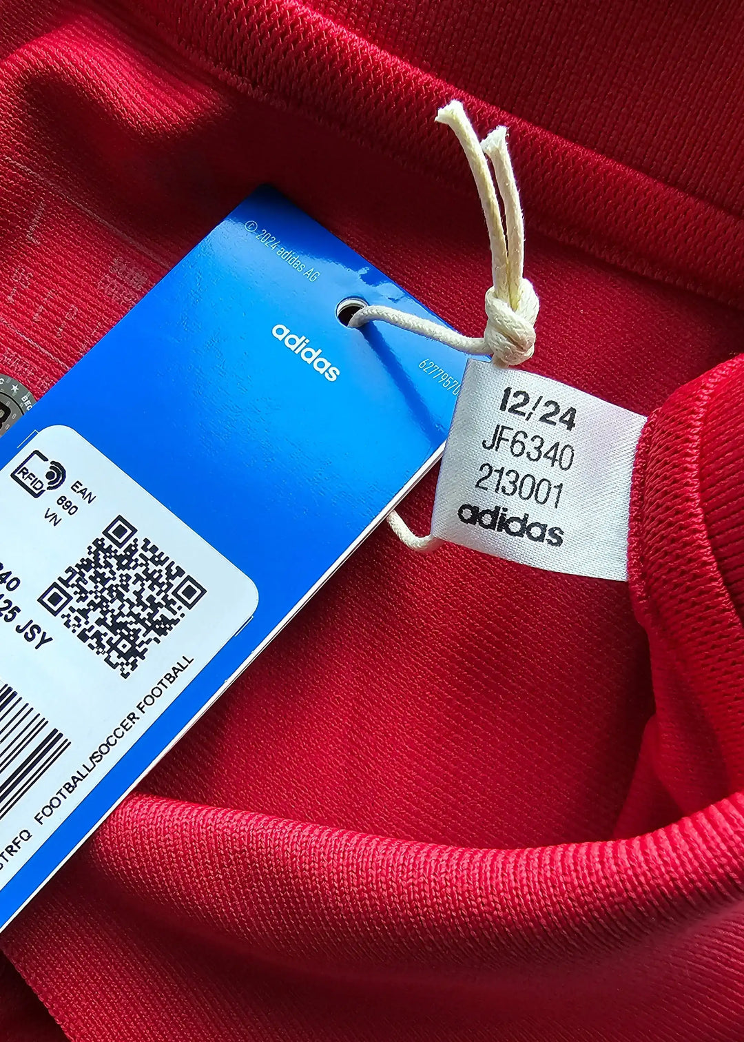 Inside view showing red fabric and adidas tag with size and style information.
