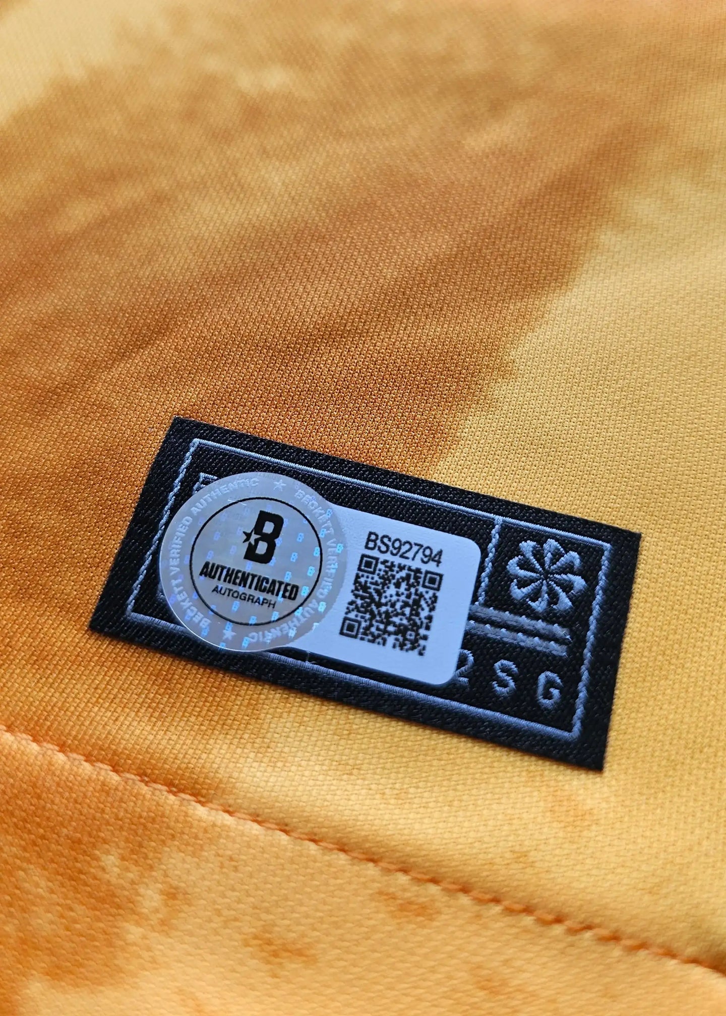 Detail showing the authentication label with the text 'AUTHENTICATED' and QR code.