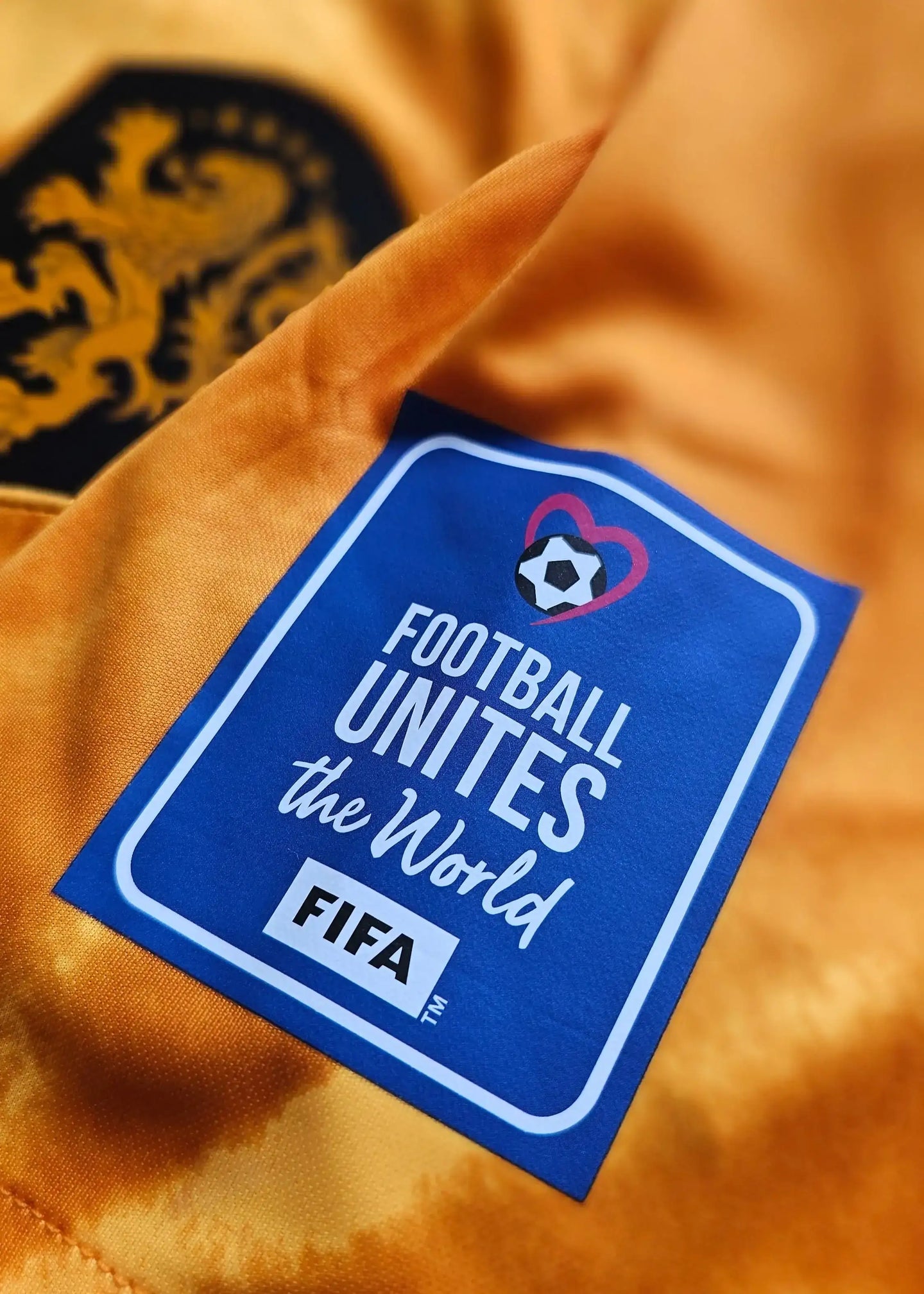 Close-up of the tag displaying 'FOOTBALL UNITES the World' along with the FIFA logo.