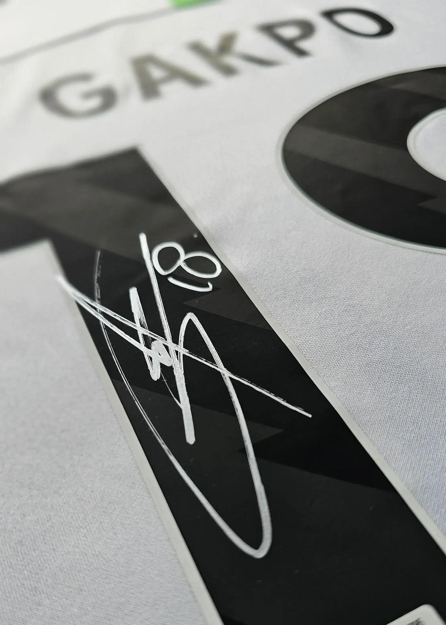 Close-up of No. 18 GAKPO with signature on back of the signed Liverpool football shirt.