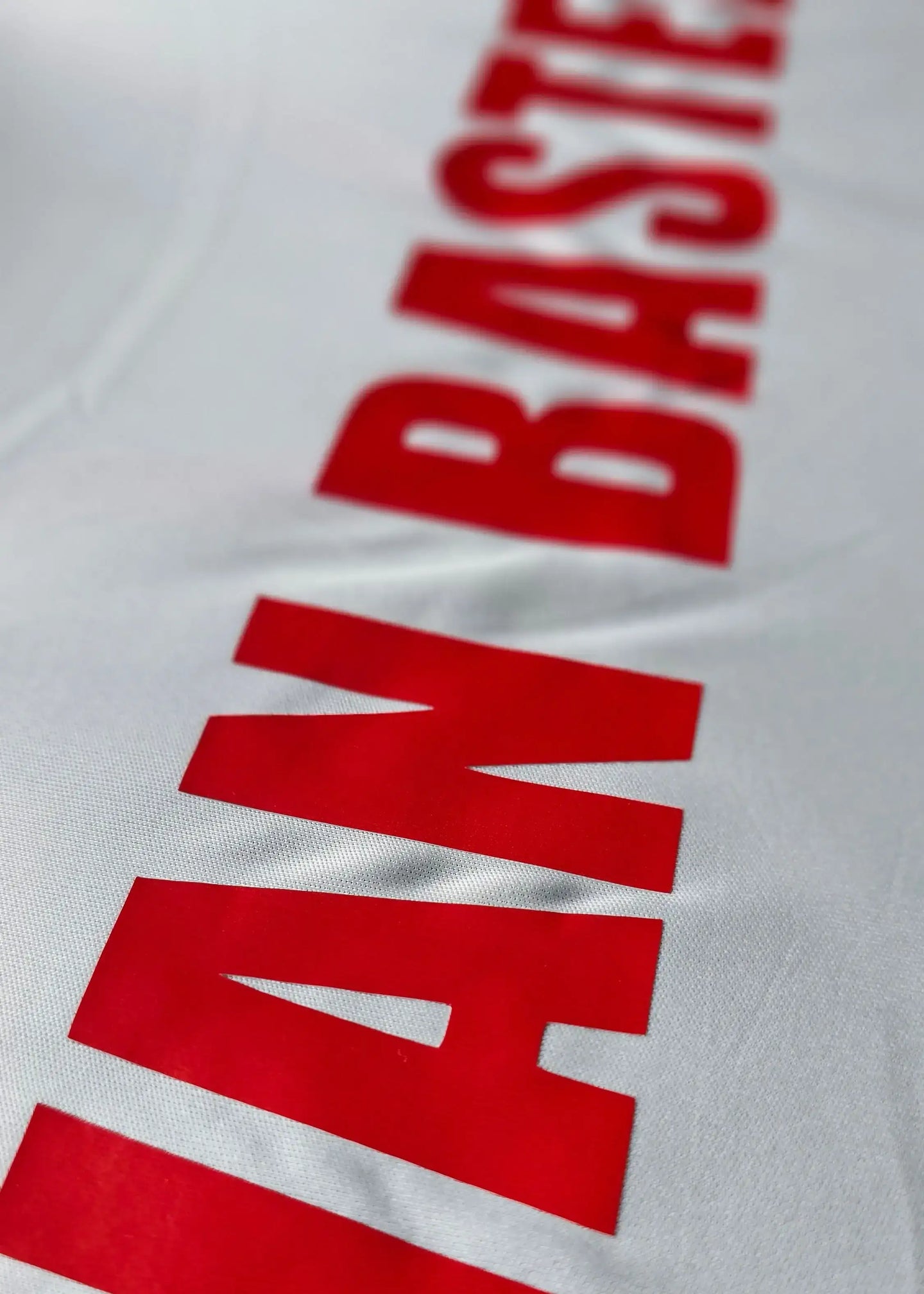 Detail view showing the name 'VAN BASTEN' in bold red letters on a white football shirt.