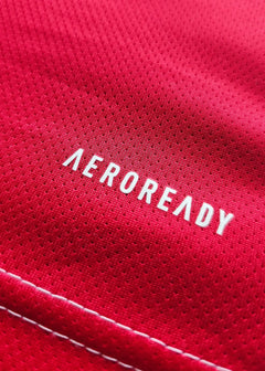 Close-up showing the word 'AEROREADY' on the red fabric of the football shirt.