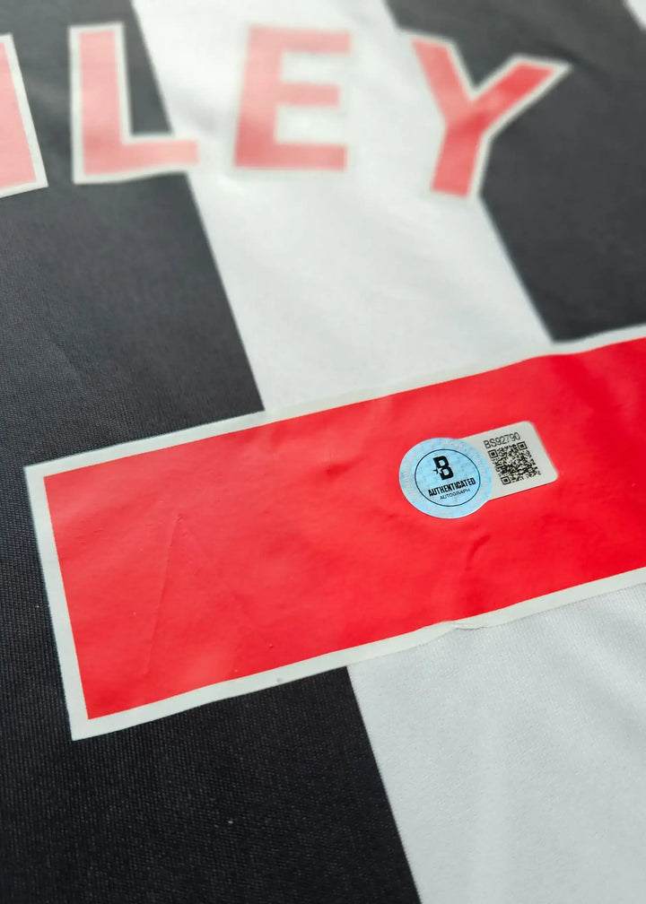 Close-up of the Lewis Miley signature detail on the Newcastle 2023-24 football shirt.