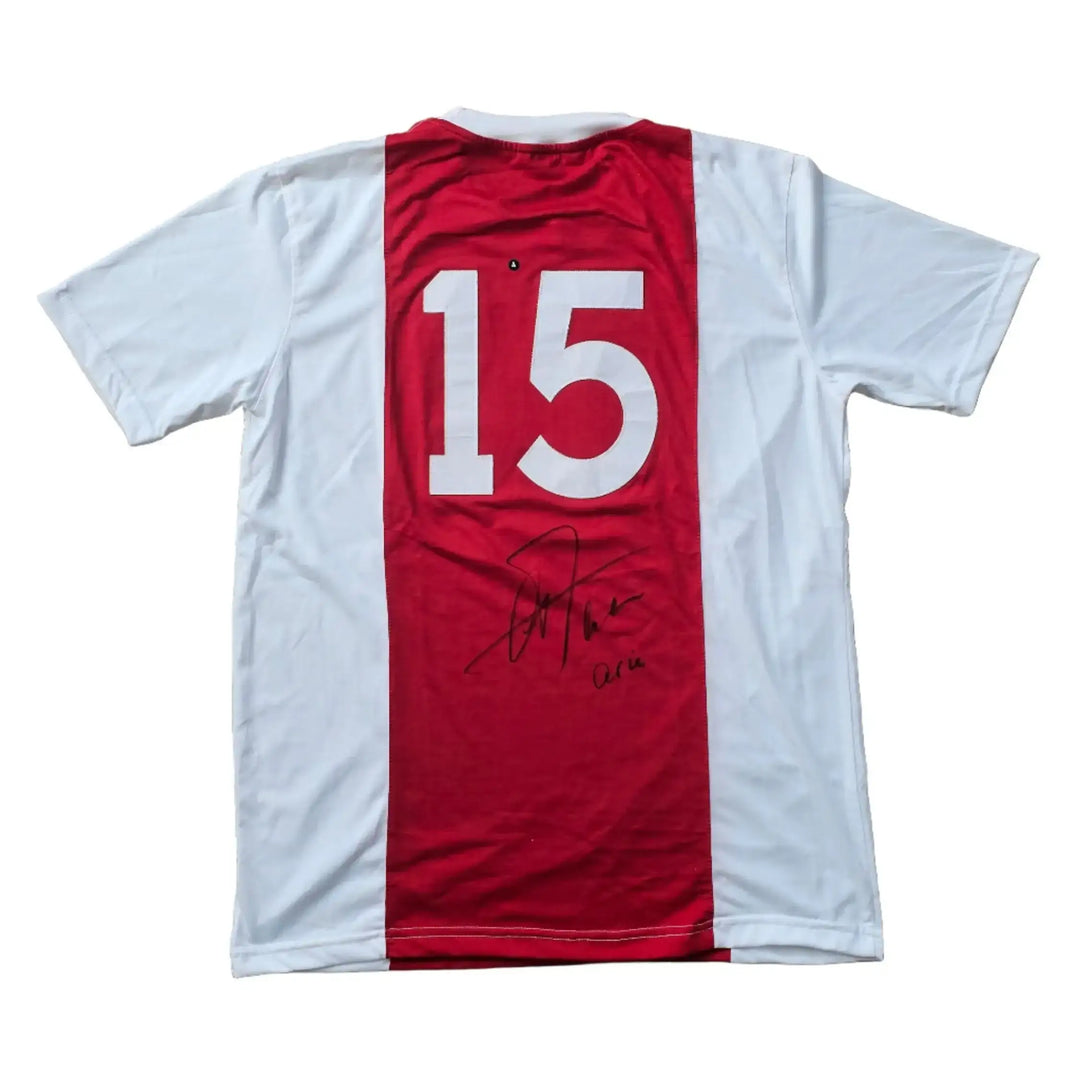 Back view of a signed Ajax football shirt featuring No. 15 and a visible signature.
