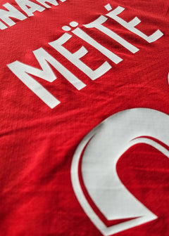 Mahomed Meïté on a red Stade Rennes shirt with number 39 and white details.