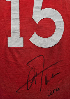 No. 15 in white on a red shirt, featuring the signature of Arie Haan.