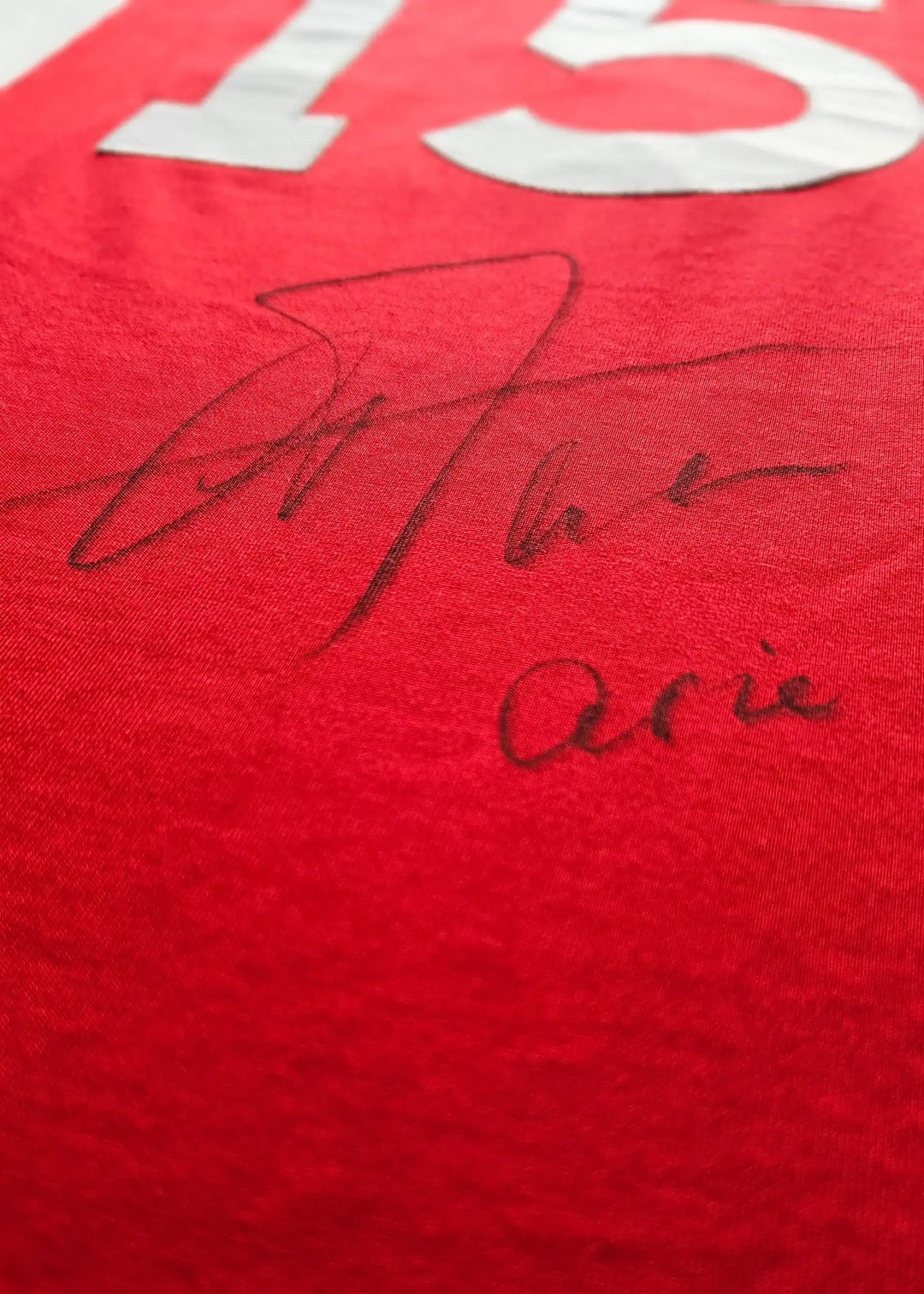 Red football shirt with No. 15 and signature of Arie Haan on the front.