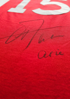 Red football shirt with No. 15 and signature of Arie Haan on the front.