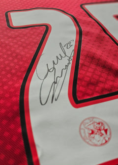 Number 25 on a red shirt featuring a signature and AFC Ajax crest detail.
