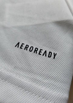 Close-up of the fabric showing the AEROREADY logo in black on a white background.