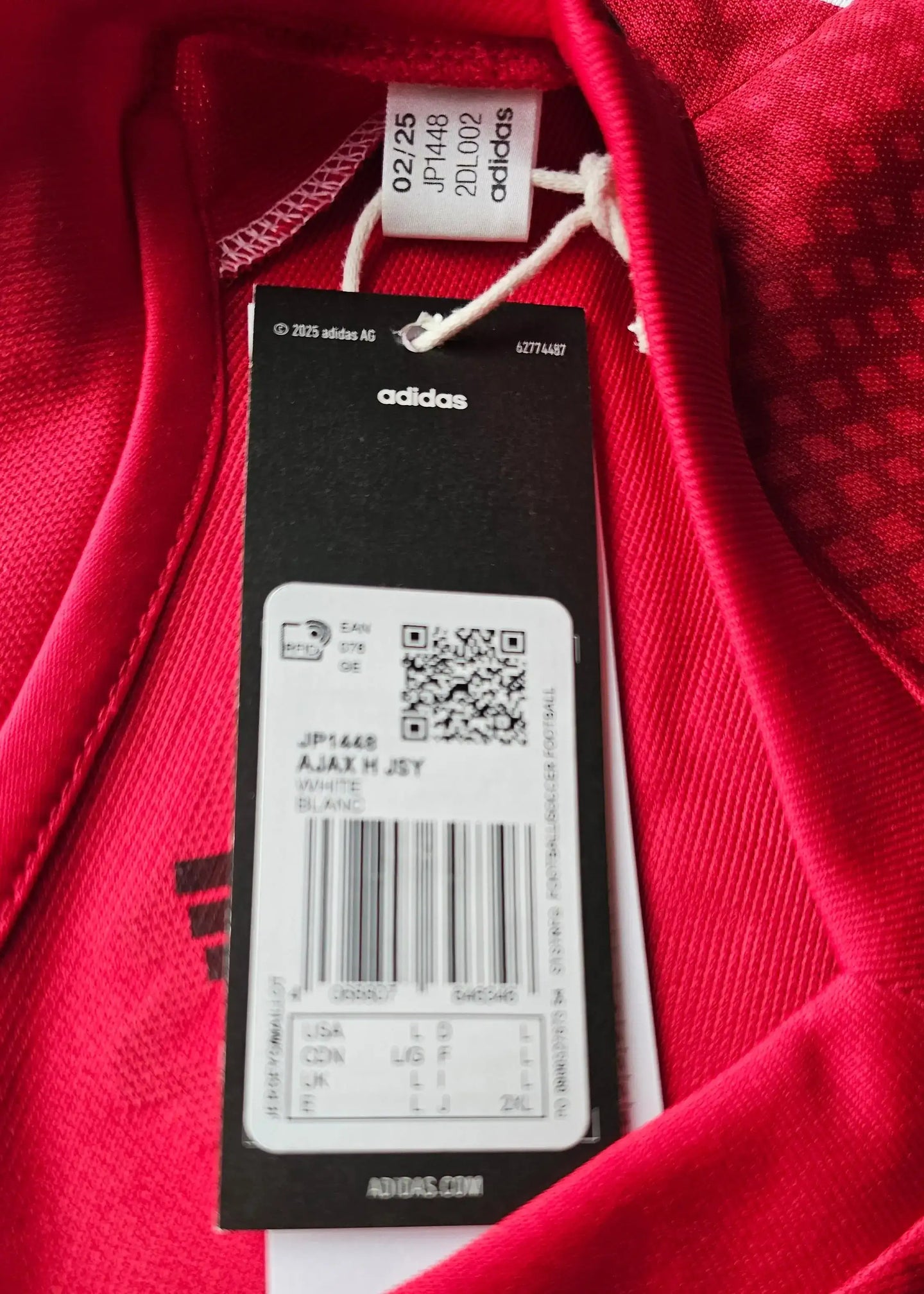 Interior view showing care label with text 'adidas', size information, and QR code.