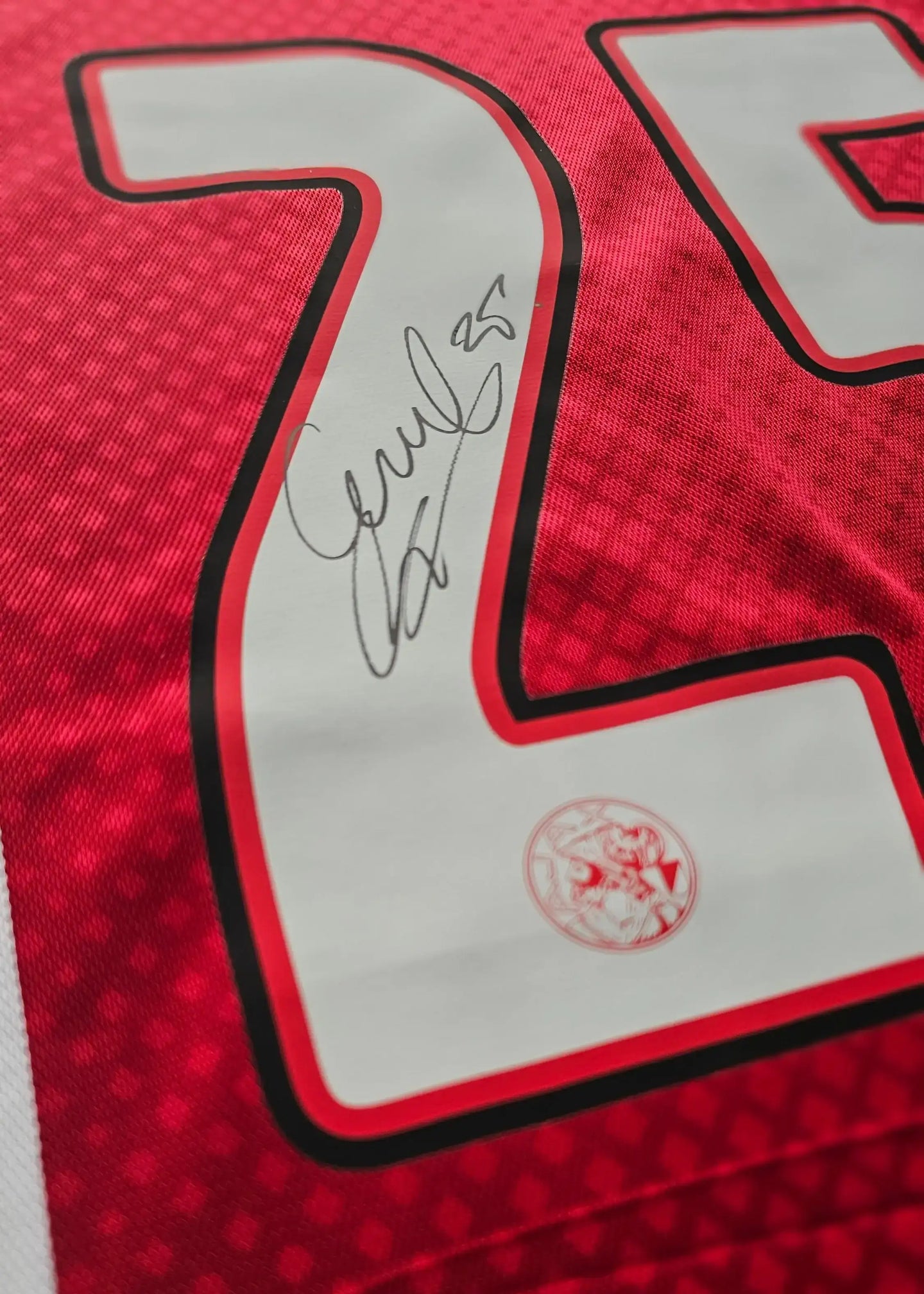 Number 25 signed by Wout Weghorst on a red Ajax football shirt with club crest.