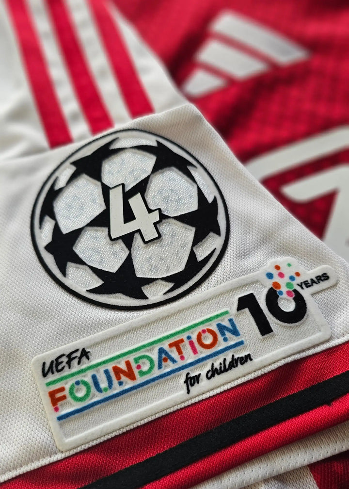 Detail showing UEFA Champions League patch with No. 25 and UEFA Foundation 10 Years logo.