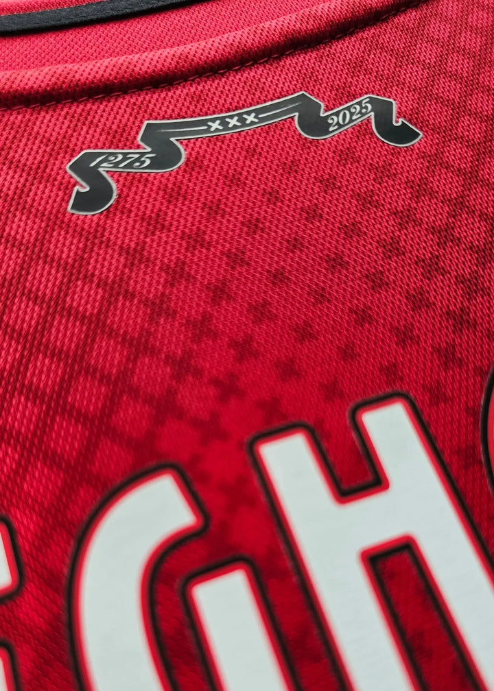 Detail view of a red soccer jersey with visible text &
