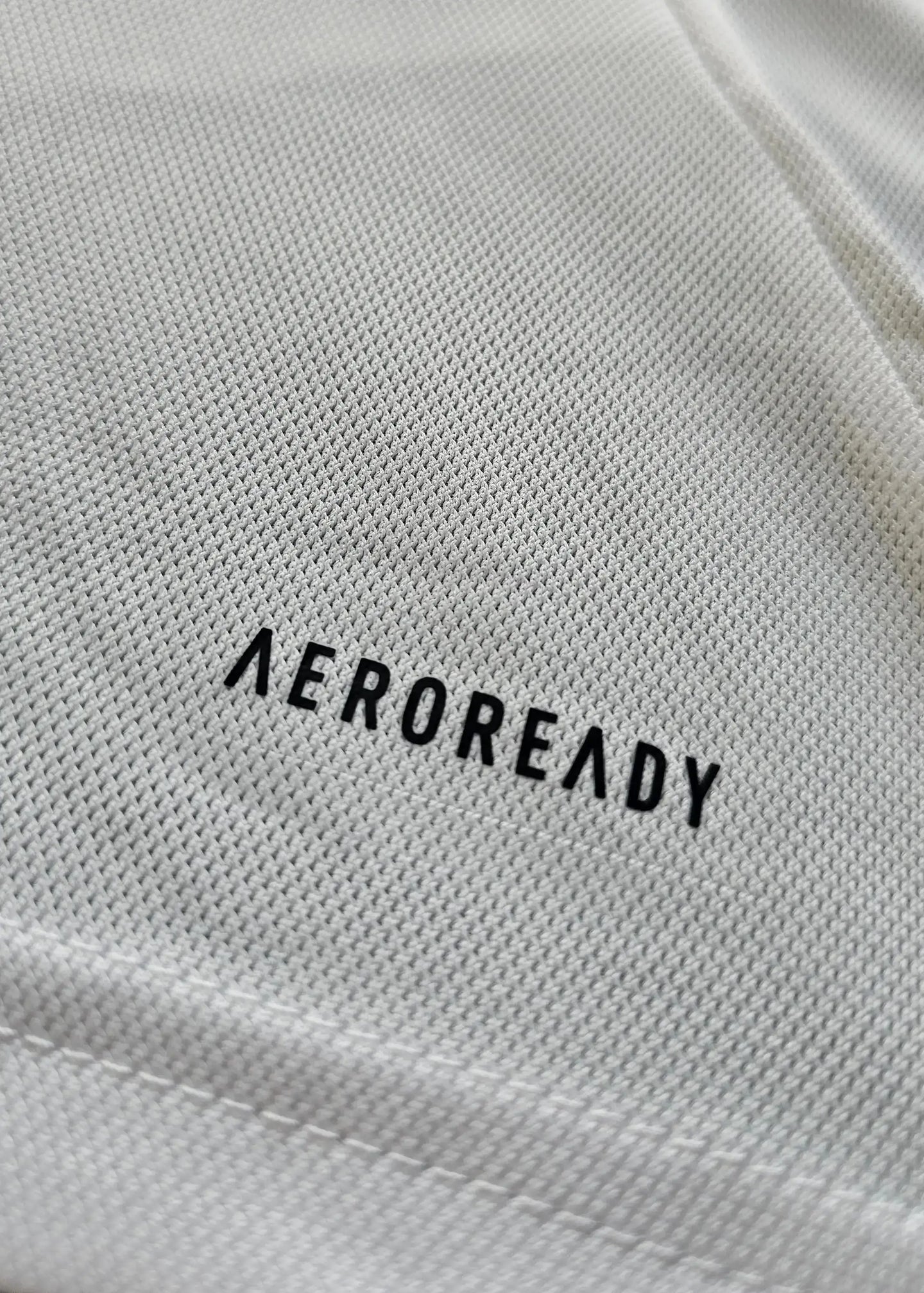 Close-up of the AEROREADY label on the fabric of the Ajax signed soccer jersey.