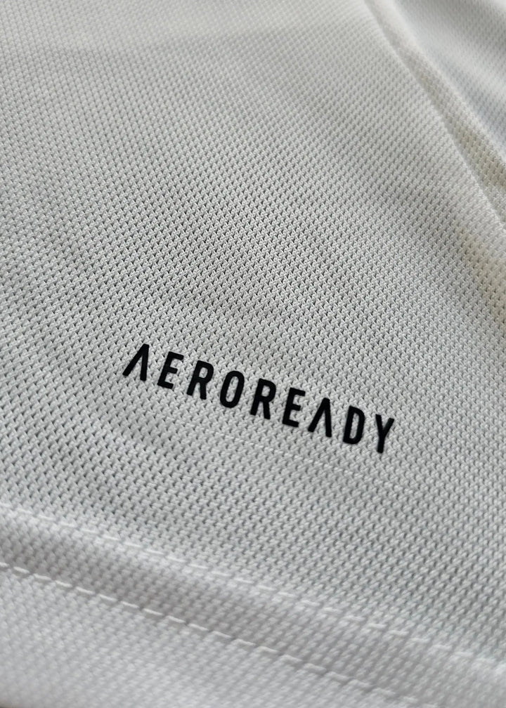 Close-up of the AEROREADY label on the fabric of the Ajax signed soccer jersey.