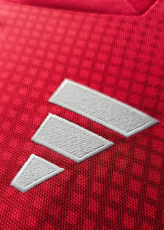 Close-up of the white adidas logo on the red fabric of Wout Weghorst's Ajax signed jersey.