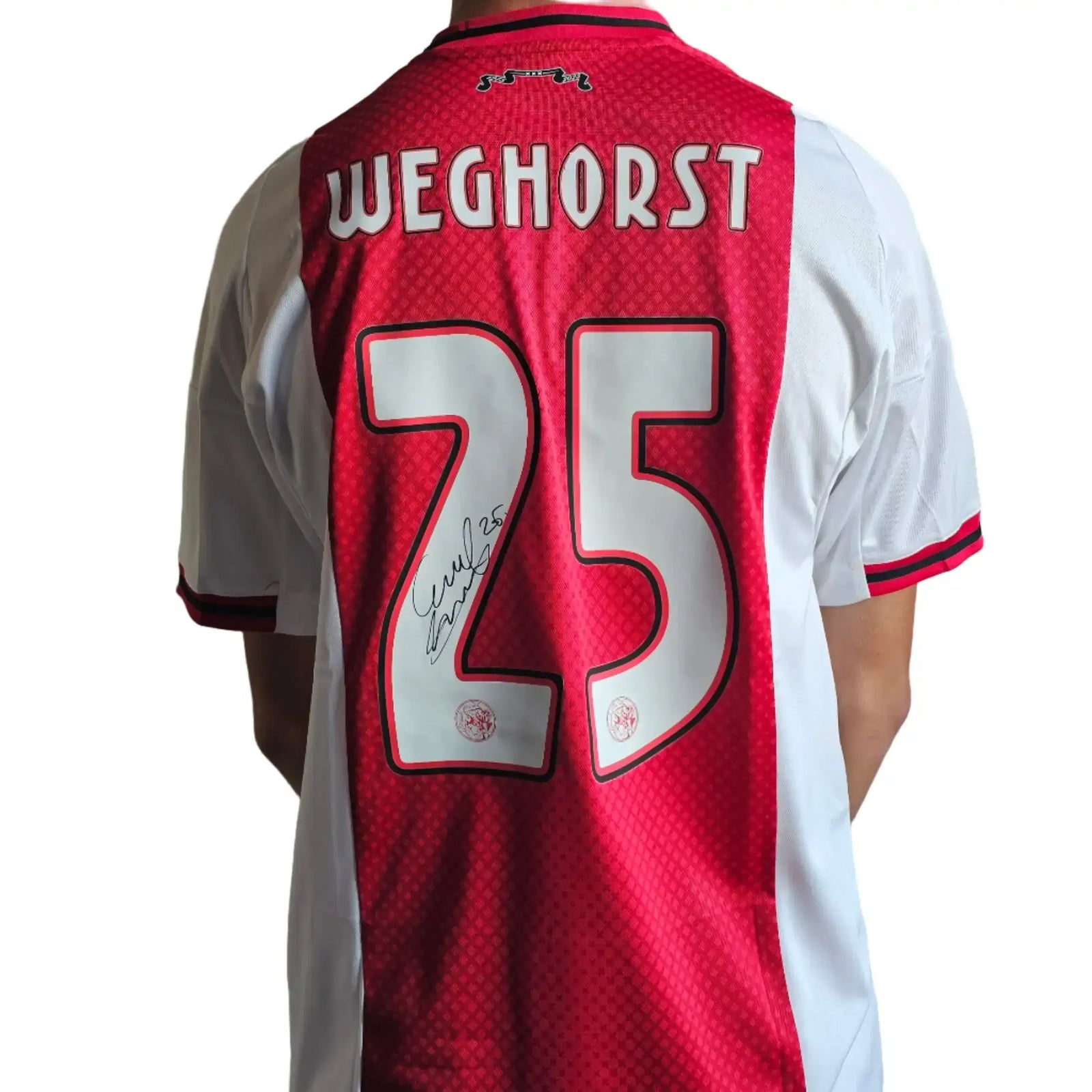 Red and white Ajax jersey featuring Weghorst, No. 25, and a visible signature.