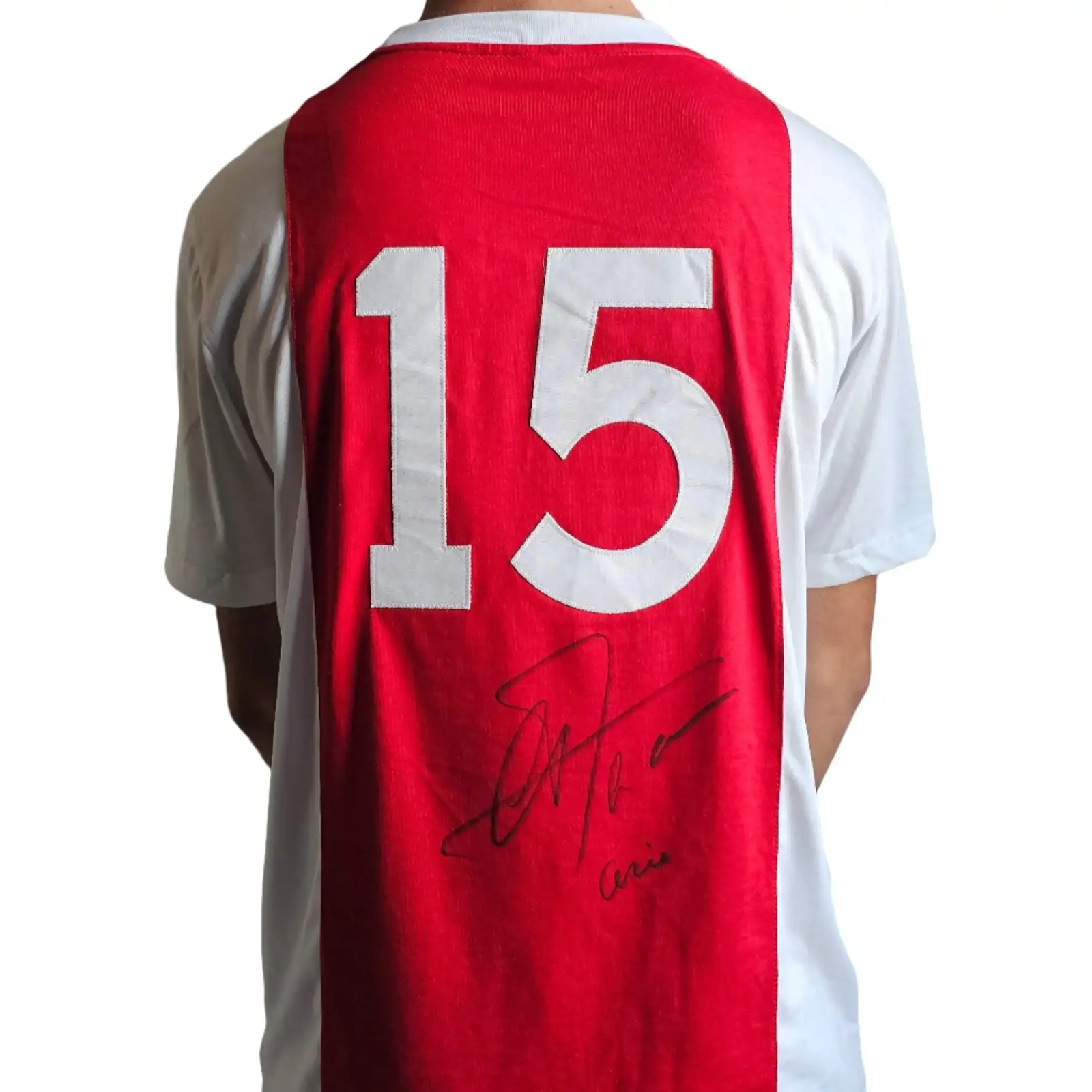 Red and white Ajax jersey with No. 15 and signature of Arie Haan displayed on the back.