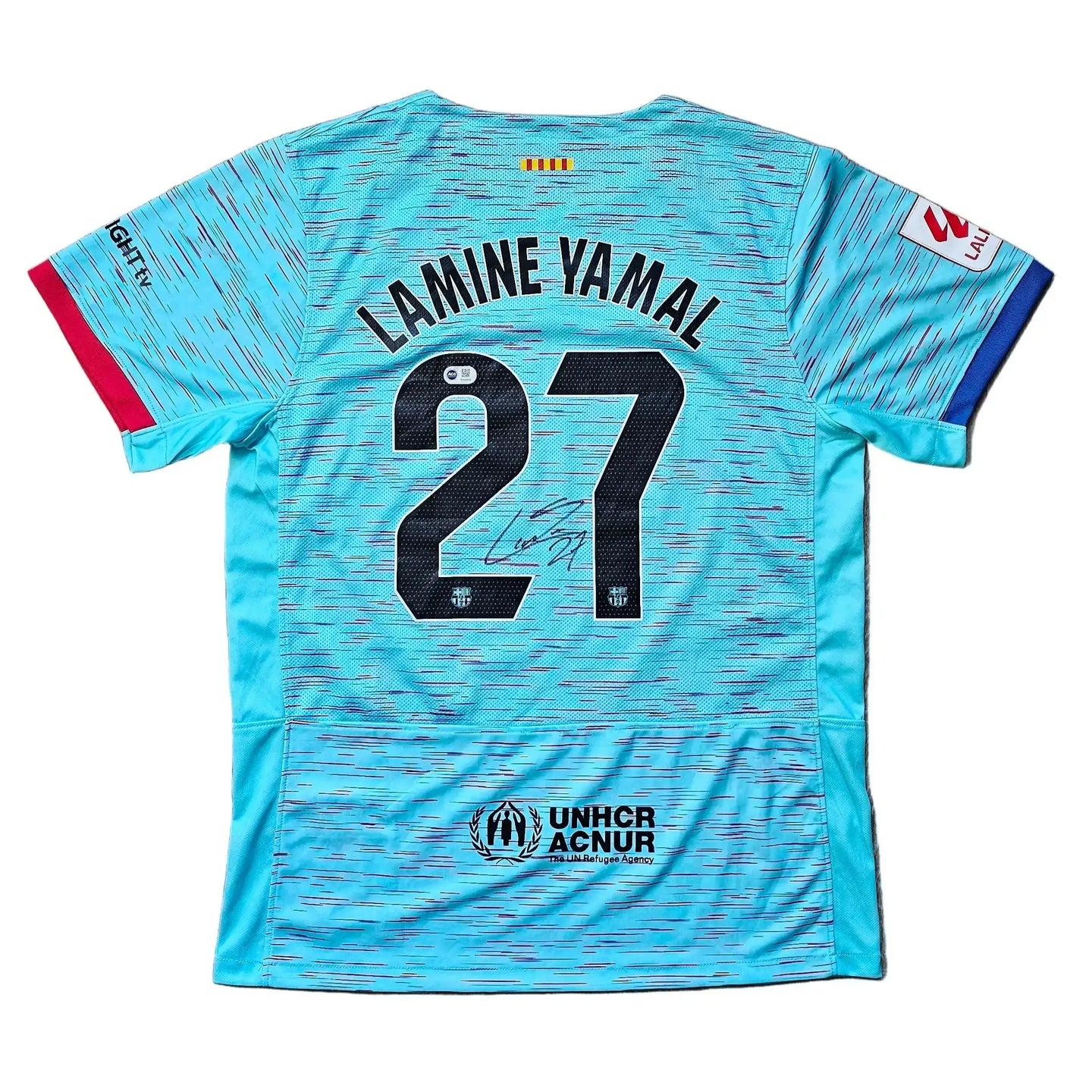 Back view of Lamine Yamal 27 Barcelona away shirt, featuring a signature and UNHCR logo.
