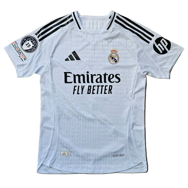 Front view of white football shirt featuring Emirates Fly Better sponsor and Real Madrid crest.