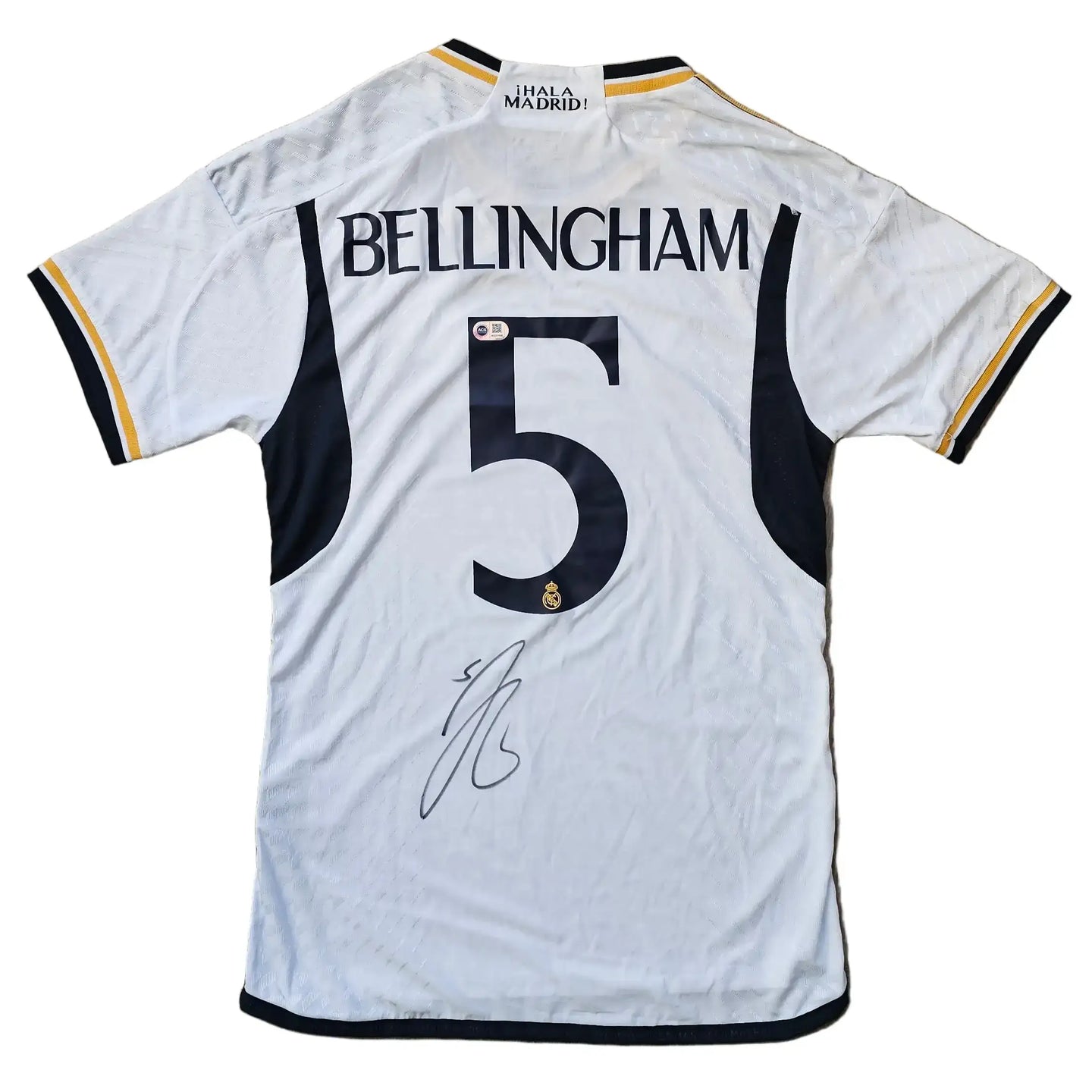 Back view of a white Real Madrid shirt featuring BELLINGHAM and No. 5 along with a visible signature.