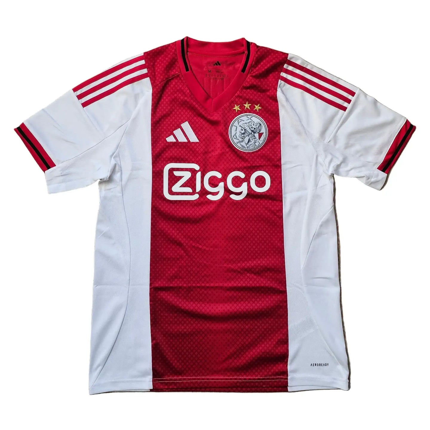 Ajax signed football shirt featuring Ziggo sponsorship, crest with three stars, and adidas branding.