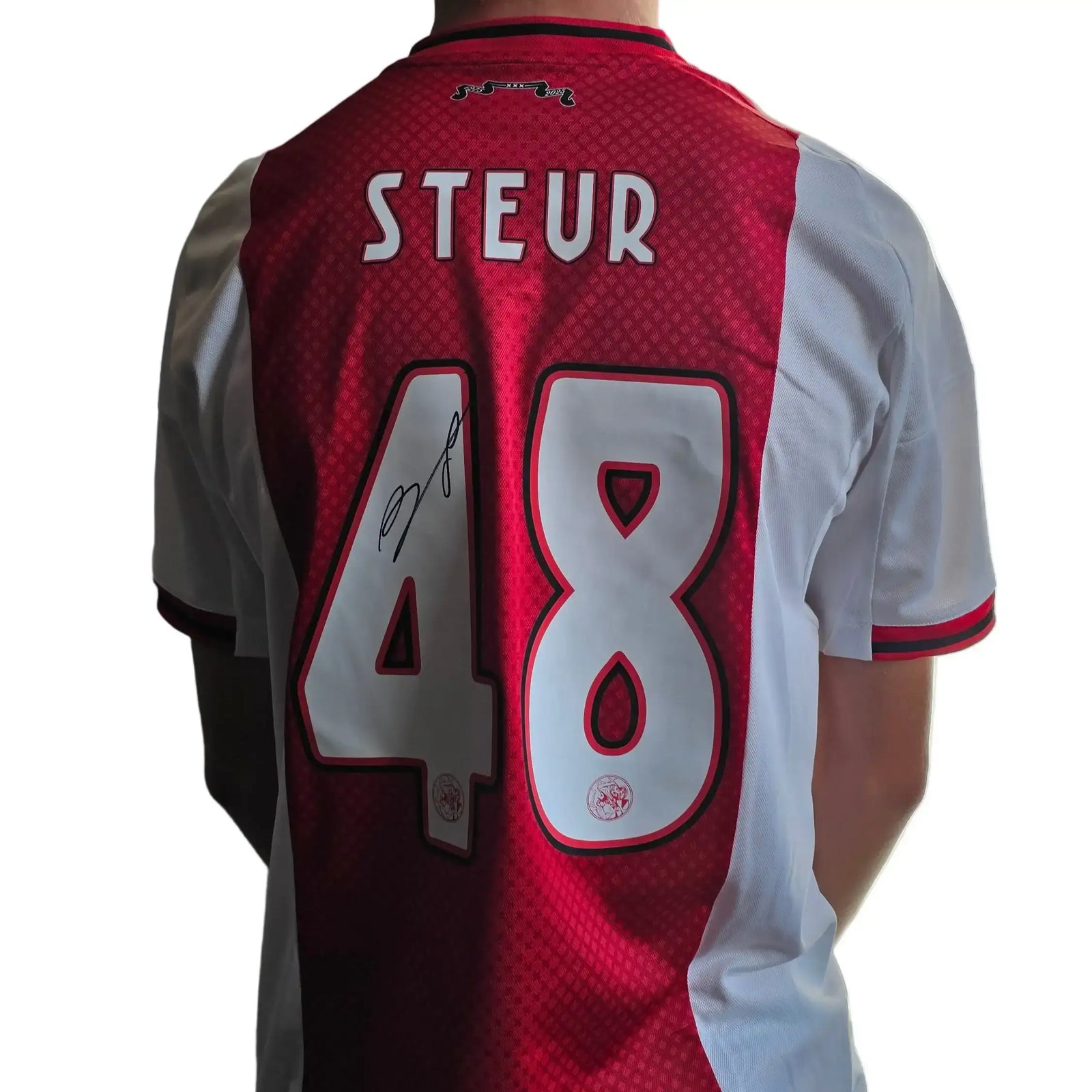 Back view of red and white Ajax shirt featuring Steur, No. 48, with a visible signature.