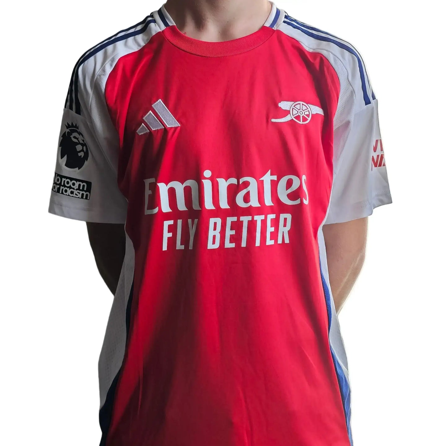 Front view of red Arsenal football shirt featuring Emirates logo and emblem.