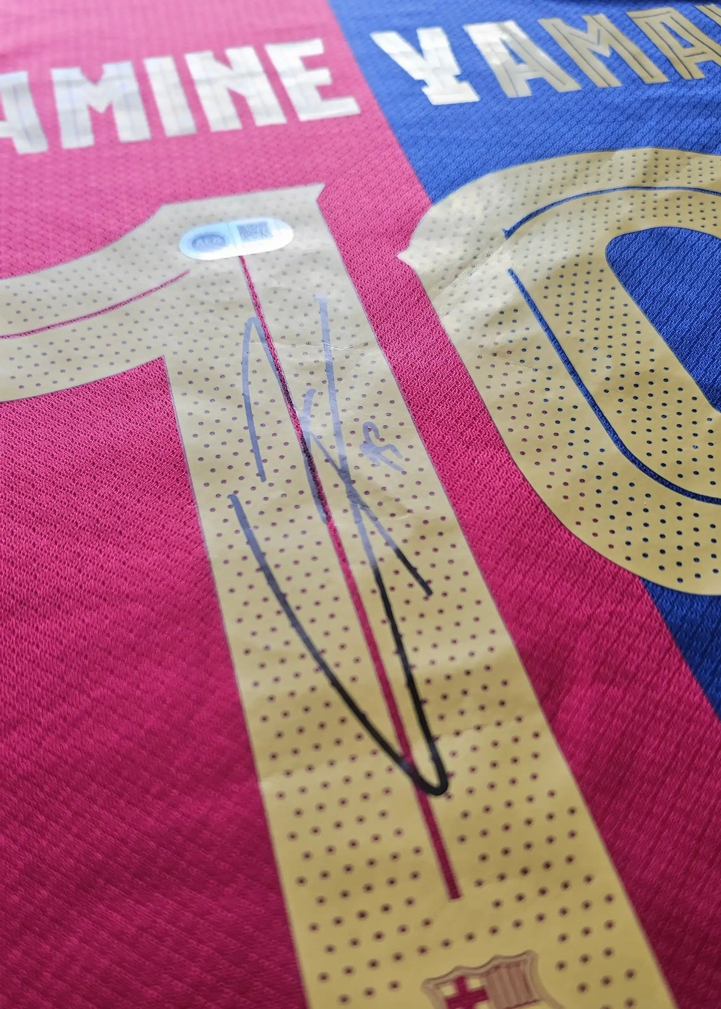 Lamine Yamal No. 10 Barcelona signed football shirt with visible signature and tag detail.