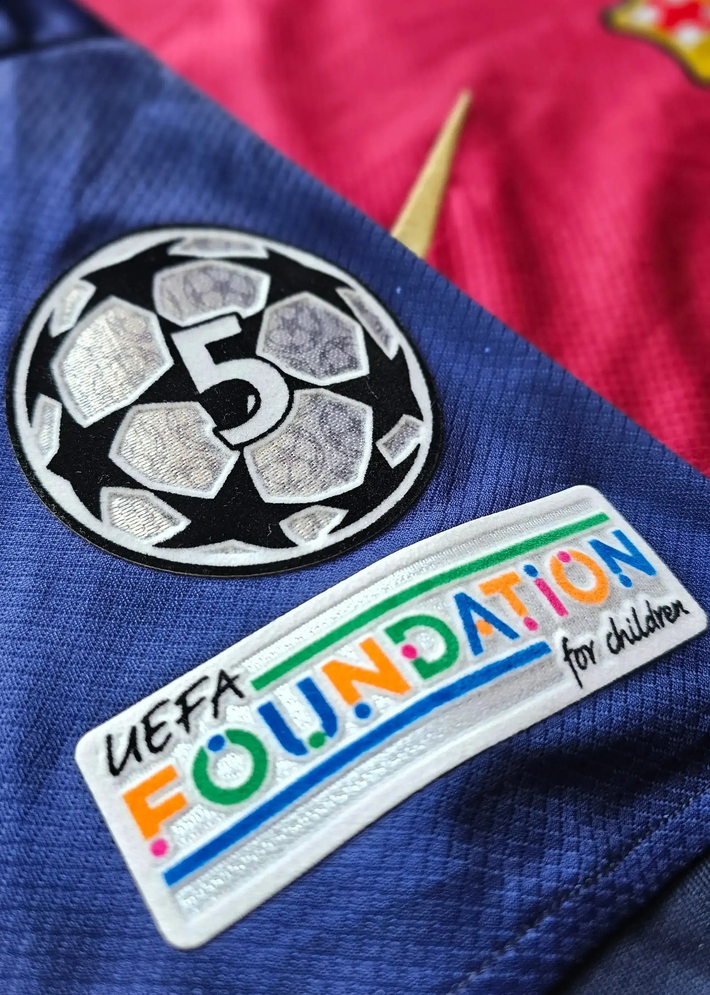 Crest featuring UEFA Foundation for children and embroidered soccer ball with number 5.