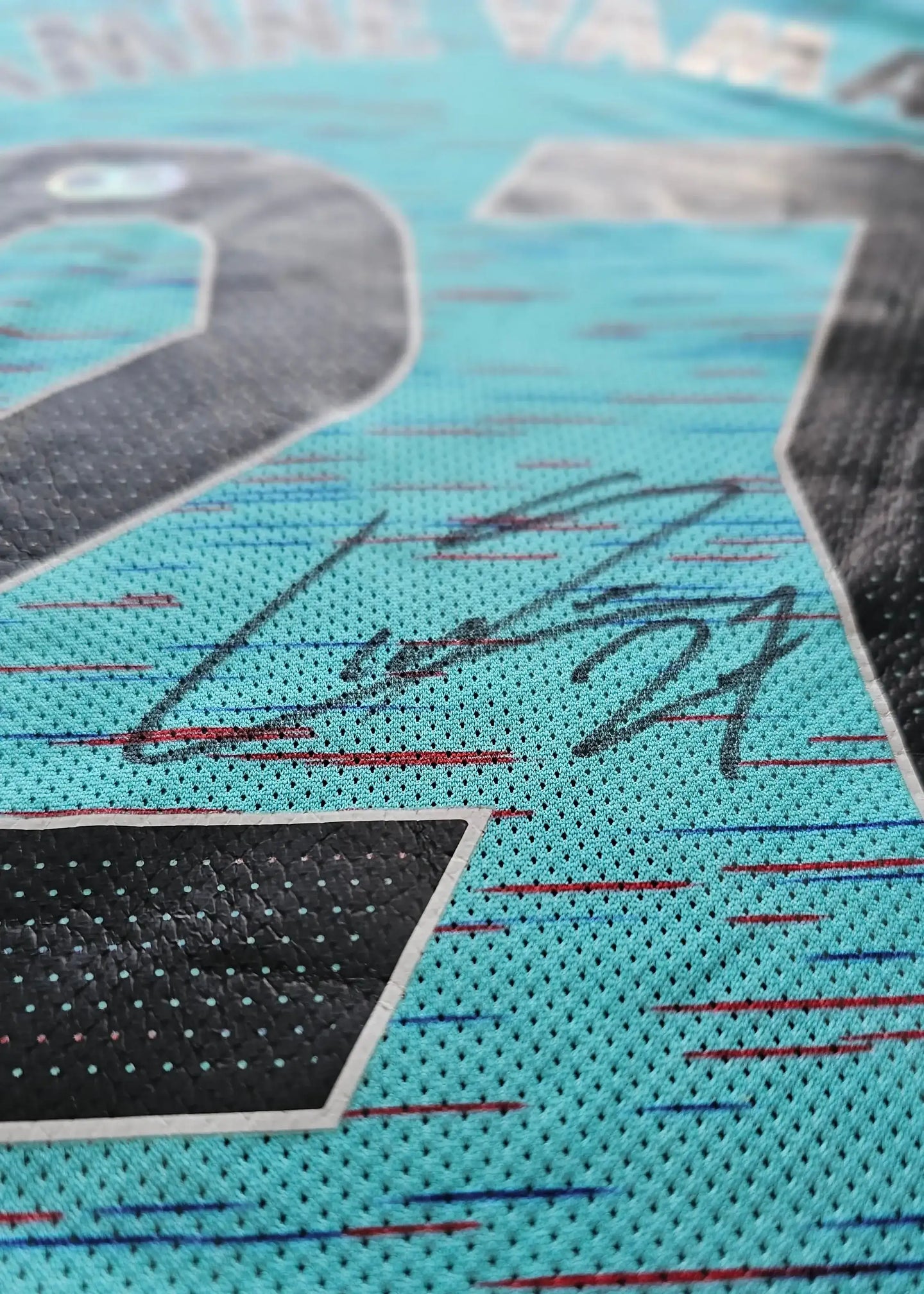 Detail of Lamine Yamal's signature on the No. 27 FC Barcelona 2023-2024 away shirt.