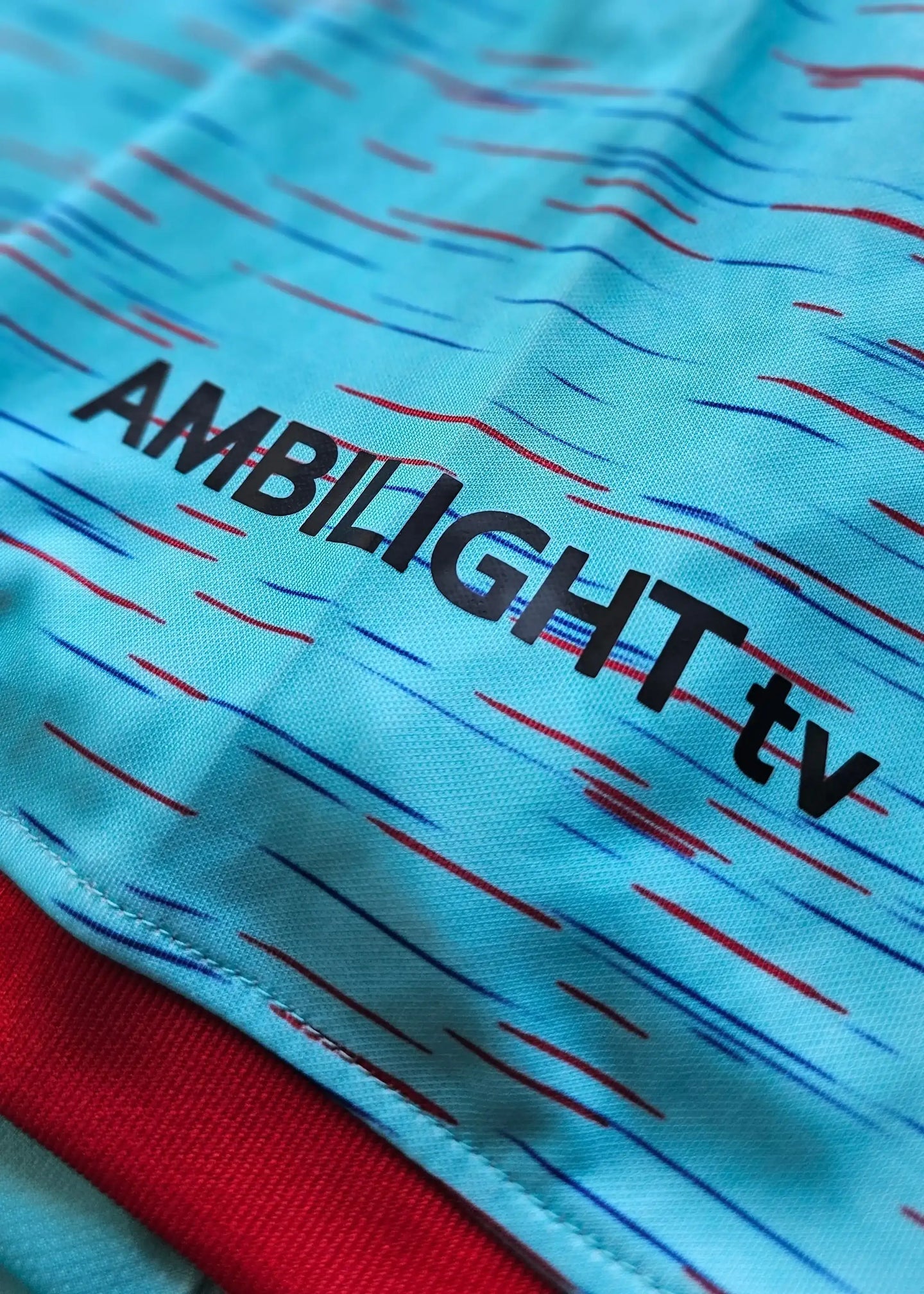 Detail of the Lamine Yamal signed Barcelona away shirt featuring AMBILIGHT tv text.