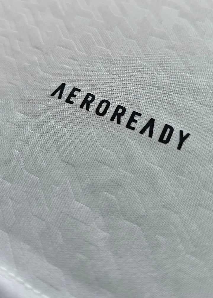 Close-up view of AEROREADY branding on the signed Kylian Mbappé football shirt.