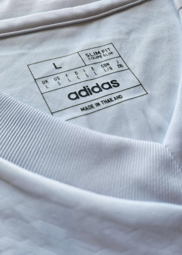 Size L label showing slim fit details and adidas branding, made in Thailand.