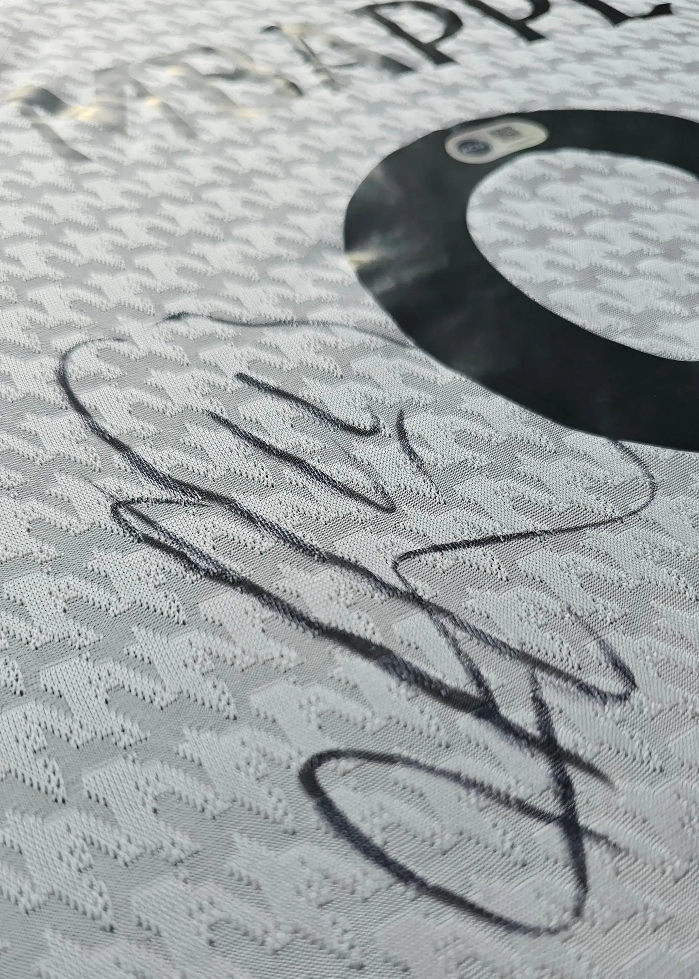 Signature detail on a Kylian Mbappé signed Real Madrid football shirt, featuring the number 9.