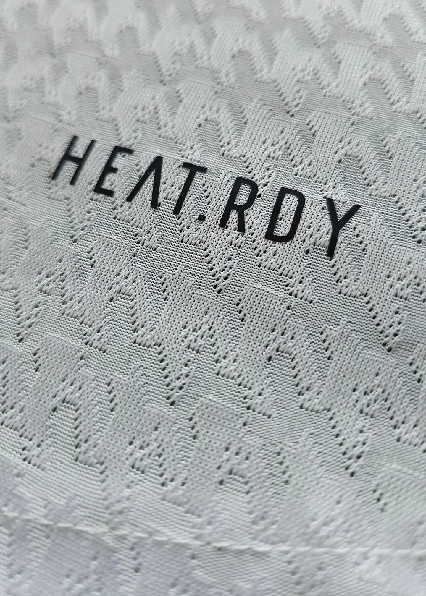 Detail of the Kylian Mbappé 9 Real Madrid signed shirt featuring HEAT.RDY text.