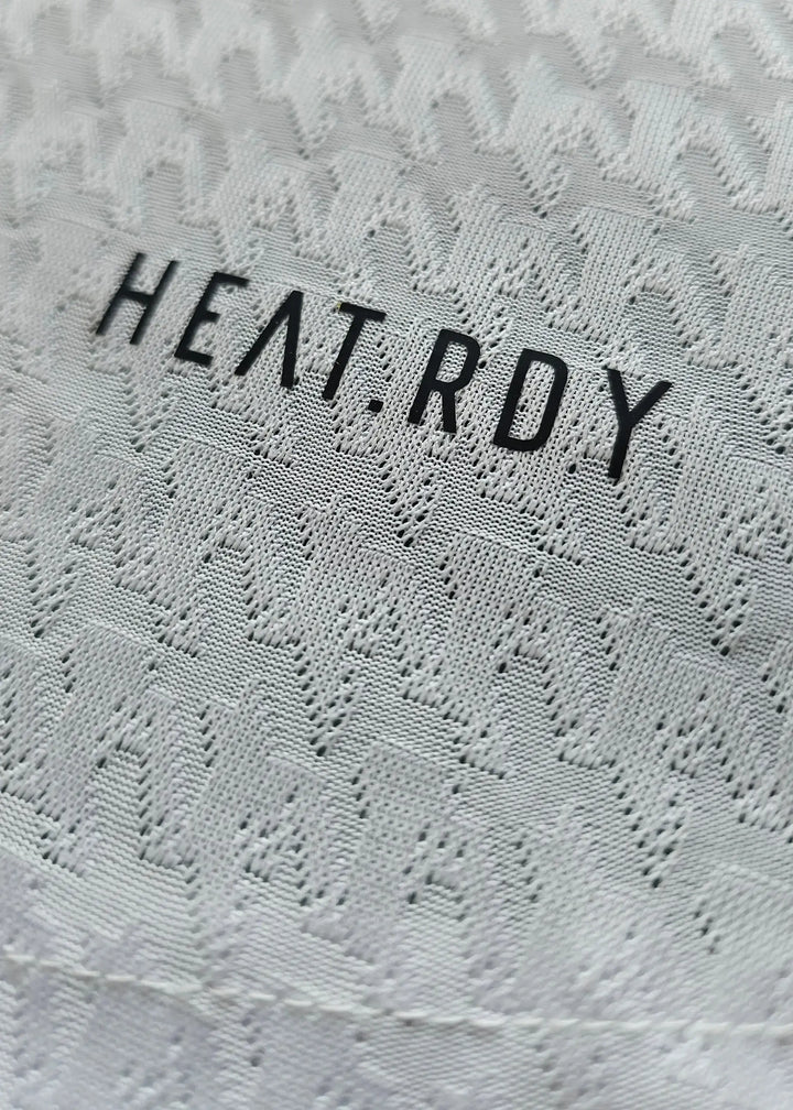 Close-up showing HEAT.RDY text on the signed football shirt of Kylian Mbappé.