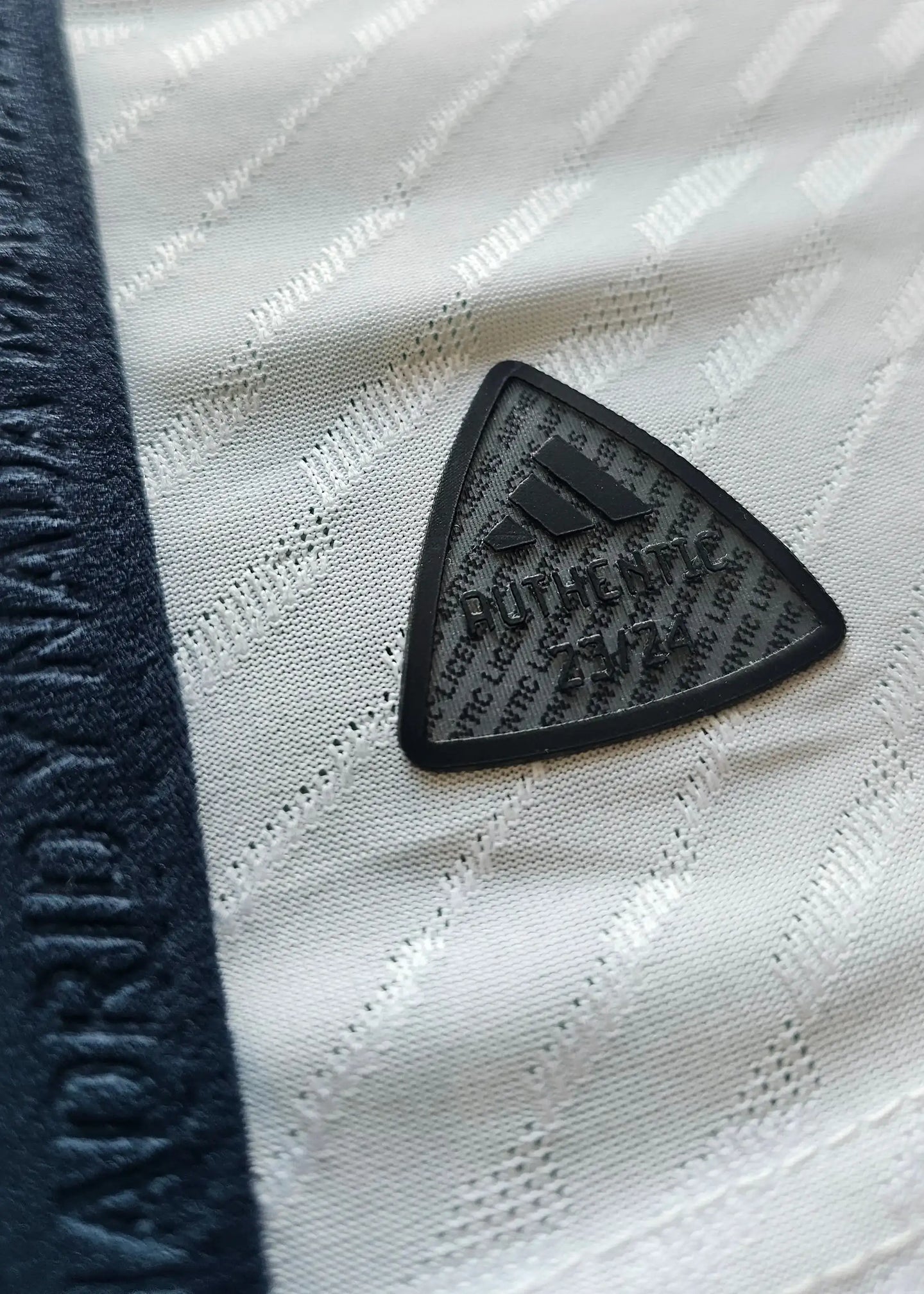 Authentic label on the Real Madrid shirt featuring adidas branding and season designation 23/24.