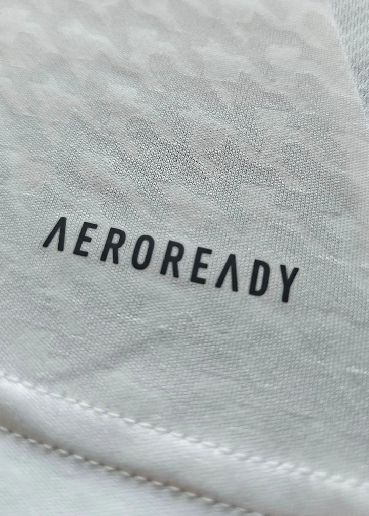 Close-up detail of the AEROREADY branding on the Jude Bellingham signed Real Madrid football shirt.
