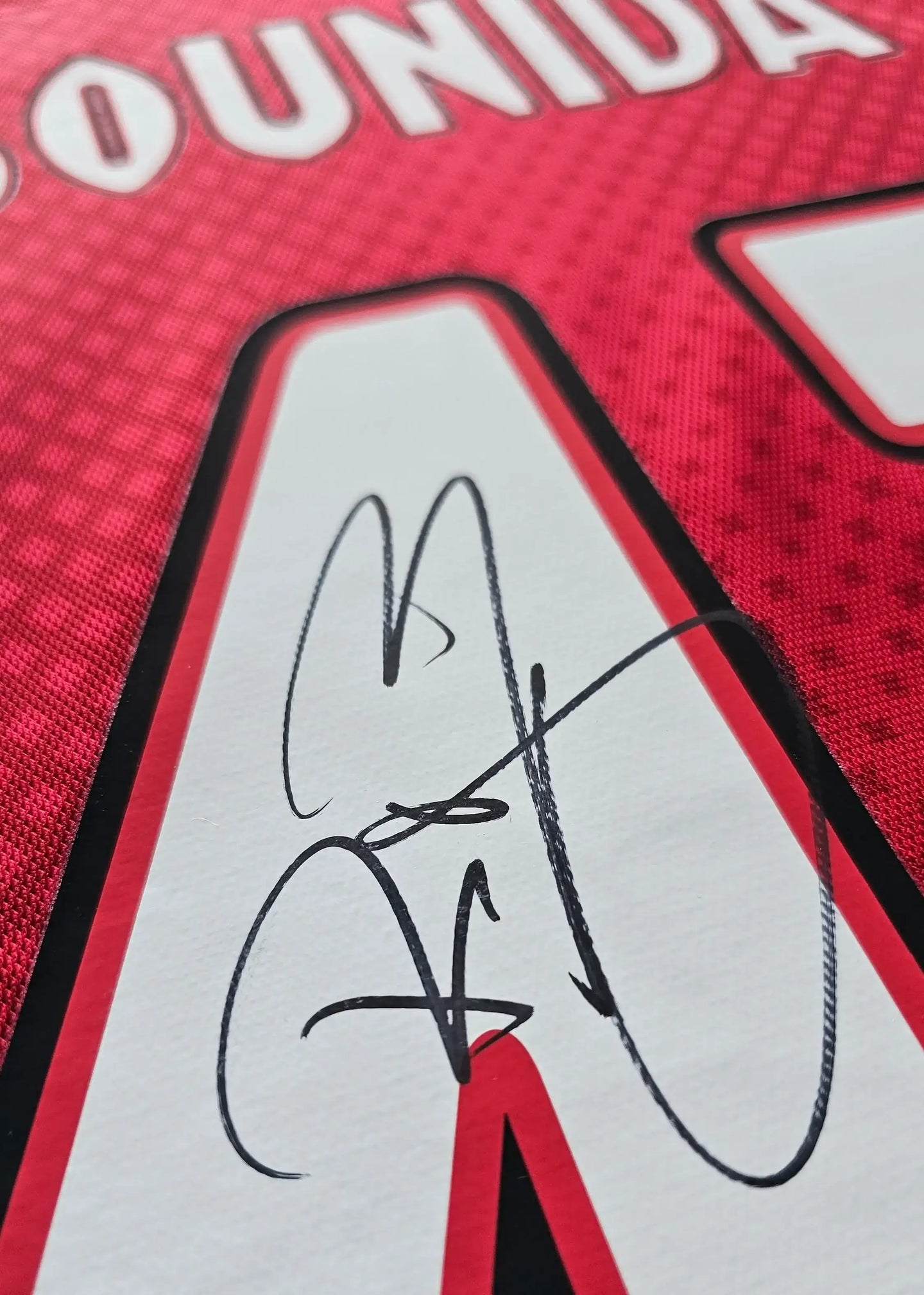 Close-up of Rayane Bounida's signature on a red Ajax shirt, featuring the No. 43.