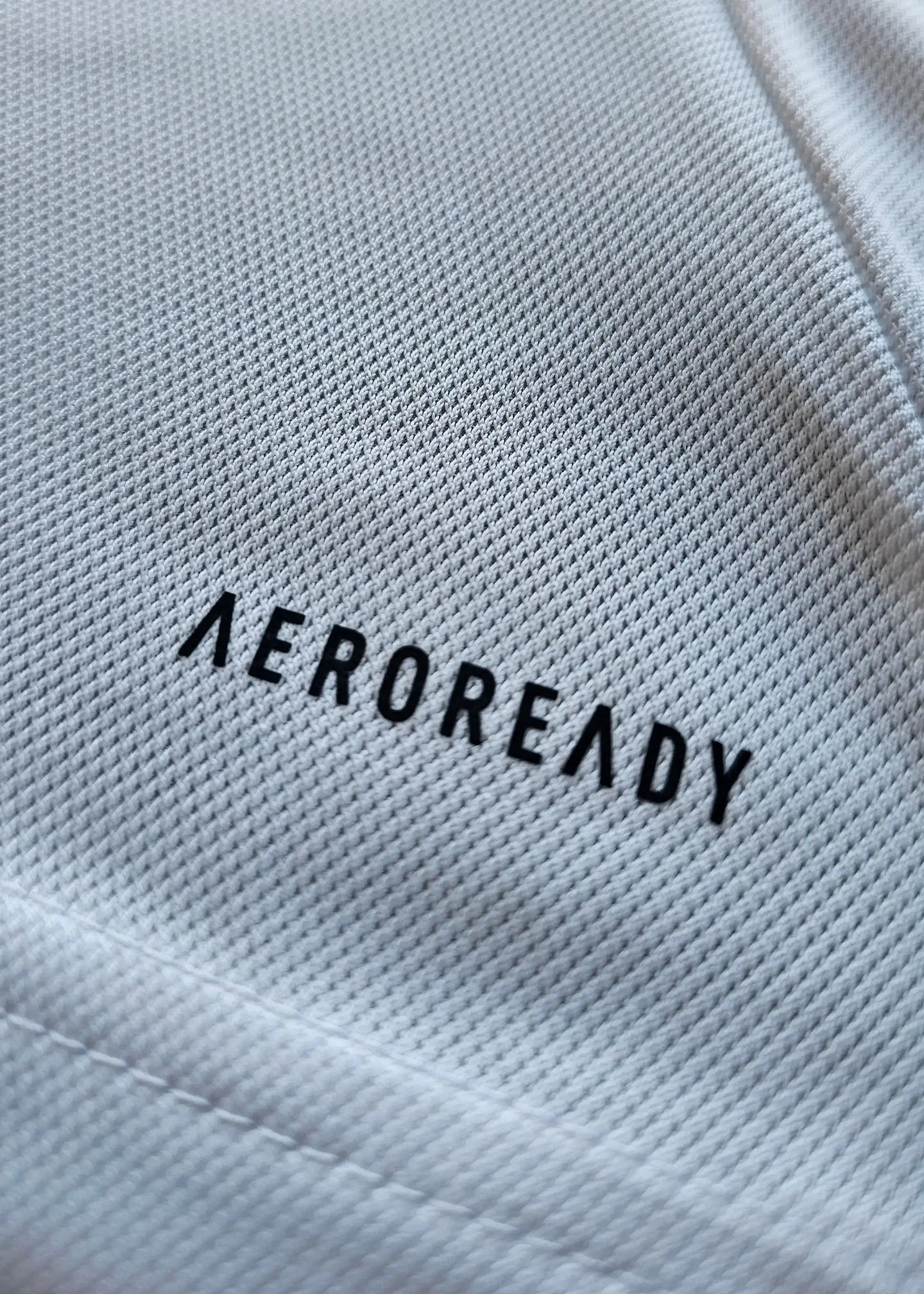 Close-up of the 'AEROREADY' label on a signed Ajax football shirt.