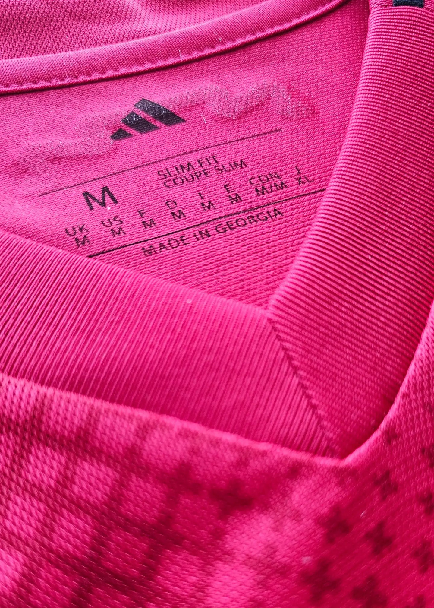 M size tag with care instructions, fabric info, and made in Georgia on the collar area.