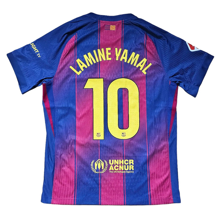 Back view showing player name Lamine Yamal and No. 10 on a blue and red football shirt with UNHCR ACNUR text.